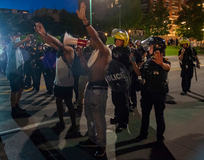 (Rick Egan  |  The Salt Lake Tribune)     Marchers agree to walk back to Washington Square in peace rather than face arrested as the police box in the crowd on South Temple after curfew, Monday, June 1, 2020.