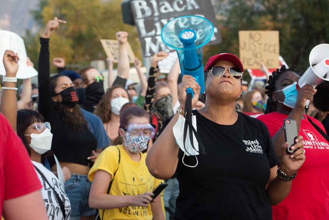 (Rick Egan  |  The Salt Lake Tribune)   Lex Scott from Black Lives Matter Utah, leads chant as counter protesters stand across the street at Cottonwood Heights police station on Monday, Aug. 3, 2020.