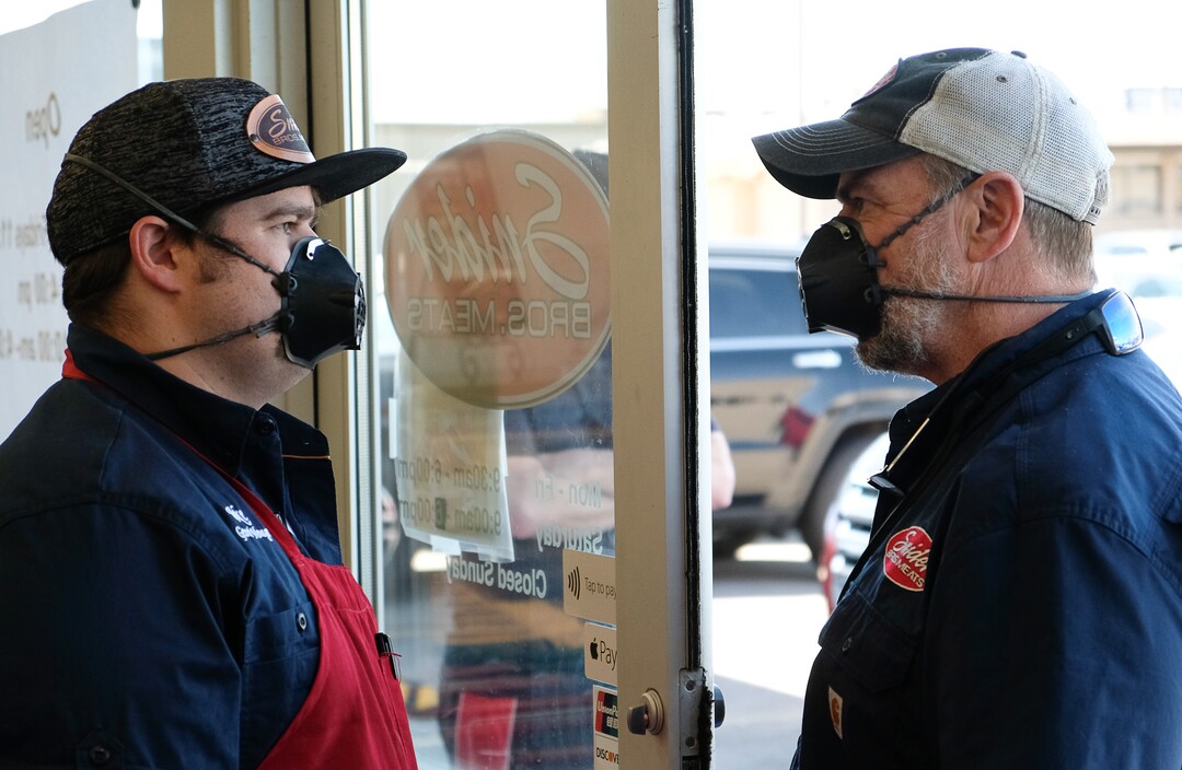 (Francisco Kjolseth  |  The Salt Lake Tribune) General Manager Jake Wilson talks with his dad Will as they control the flow of customers visiting their store Snider Brothers Meats in Cottonwood Heights on Tuesday, May 5, 2020, in order to keep safe social distancing.