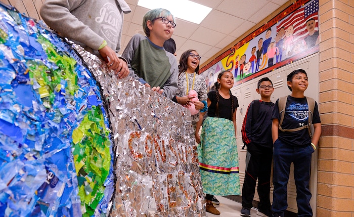(Leah Hogsten  |  The Salt Lake Tribune) Students at Parkview Elementary have created a treasure with trash. Ten fifth graders in Cher Sten's extended learning program or ELP class, molded school and household plastic refuse into a mosaic to send the message: "Consume Less" to their classmates. The idea for the mural began after a discussion about global warming, climate issues, plastic pollution and its implications on earth.