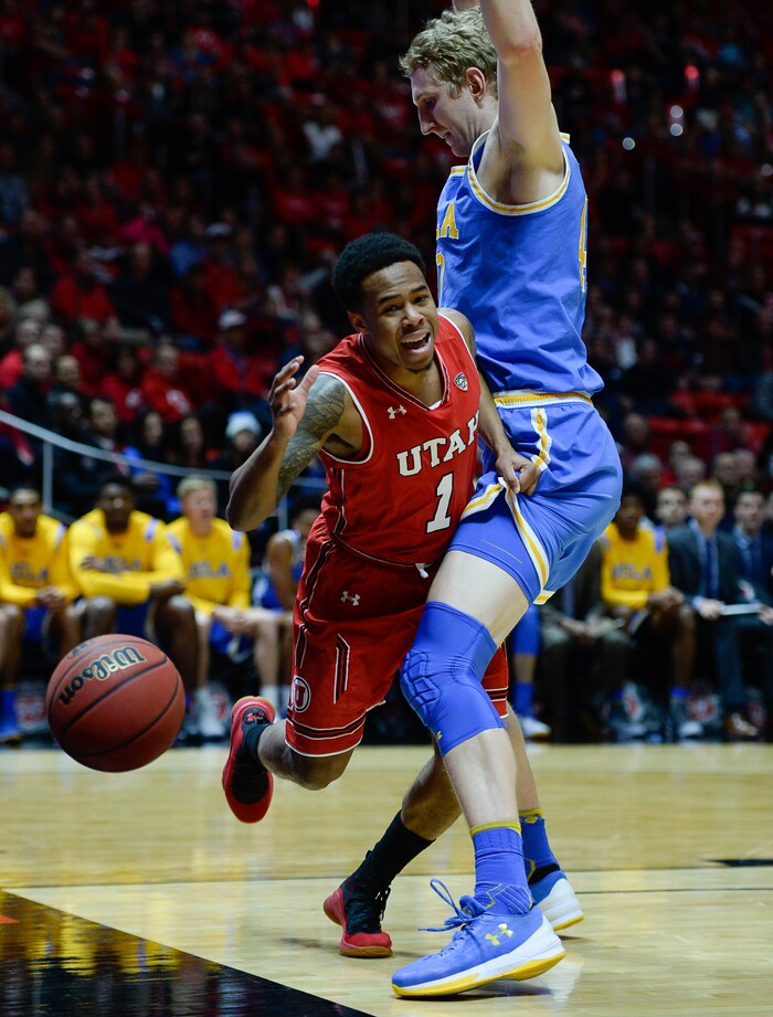 (Francisco Kjolseth  |  The Salt Lake Tribune)  Utah Utes guard Justin Bibbins (1) goes up against UCLA Bruins center Thomas Welsh (40) as the University of Utah hosts UCLA in NCAA basketball at the Huntsman Center in Salt Lake City, Thursday, Feb. 22, 2018.