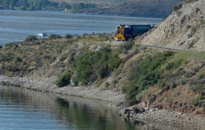 (Scott Sommerdorf | The Salt Lake Tribune) The Heber Creeper train rounds a corner next to Deer Creek Reservoir on the last leg of the race versus runners finishing at the Soldier Hollow train station. The race started at the Deer Creek Dam, Saturday, August 19, 2017.