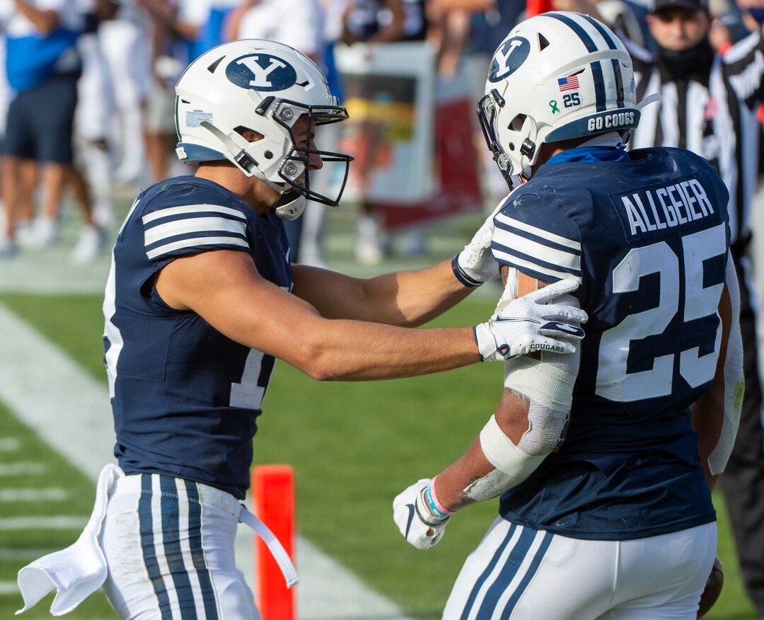 (Rick Egan  |  The Salt Lake Tribune)    Brigham Young Cougars wide receiver Gunner Romney (18) congratulates Brigham Young running back Tyler Allgeier (25) on his touchdown, in football action between the Brigham Young Cougars and the UTSA Roadrunners, at Lavell Edwards stadium, Saturday, Oct. 10, 2020.