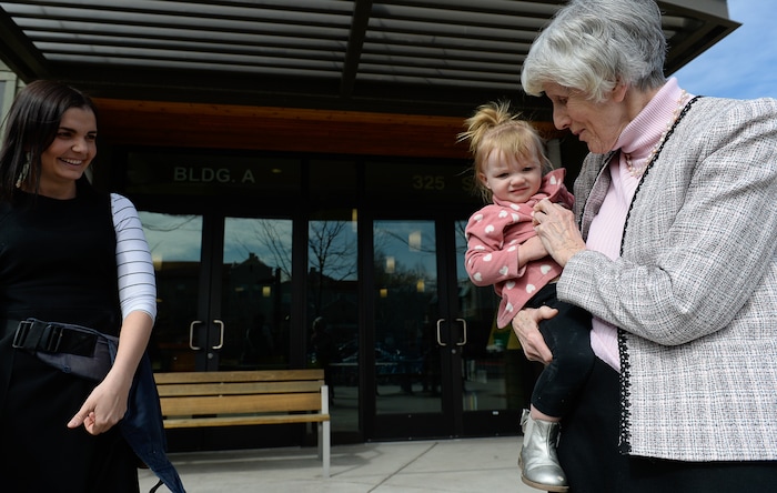 (Francisco Kjolseth | The Salt Lake Tribune) Eva May Densley, 1, carried by her mother Michelle, calls out "grandma" after catching a glimpse of champion for the homeless Pamela Atkinson while touring the YWCA Center for Women & Familes in Salt Lake on Tuesday, March 20, 2018. Michelle, a mother of three who lived out of her car and peoples homes for a time feels blessed to have landed an apartment at the women's center after experiencing violent abuse from her former husband during her pregnancy with Eva. Atkinson is encouraging people to donate to the Pamela Atkinson Homeless Trust Fund through their tax forms.