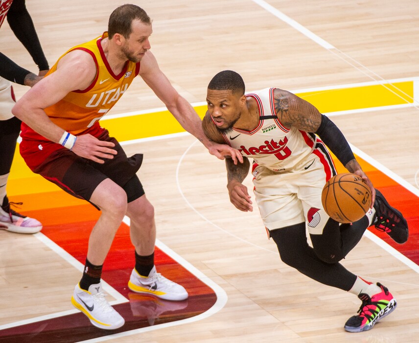 (Rick Egan  |  The Salt Lake Tribune)     Portland Trail Blazers guard Damian Lillard (0)  dribbles around Utah Jazz guard Joe Ingles (2), in the Jazz 117-114 win over the Portland Trail Blazers, in NBA action in Salt Lake City, Friday, Feb. 7, 2020.