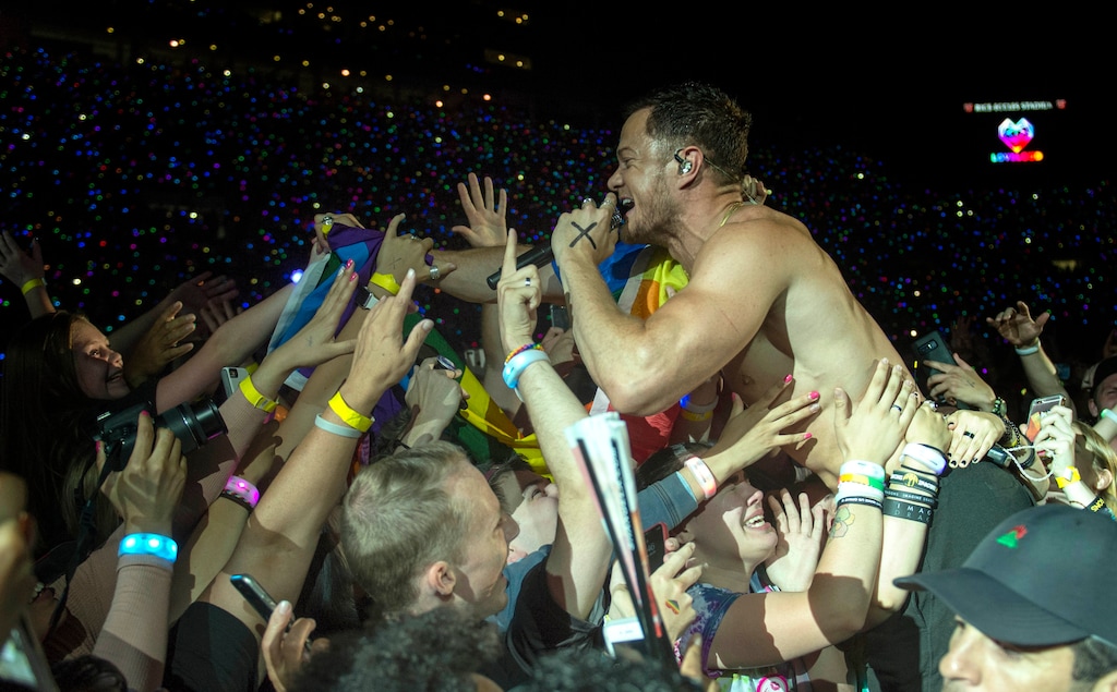 (Rick Egan  |  The Salt Lake Tribune)     Dan Reynolds jumps into the crowd as he performs with Image Dragons at the Loveloud Festival at Rice-Eccles Stadium, Saturday, July 28, 2018.