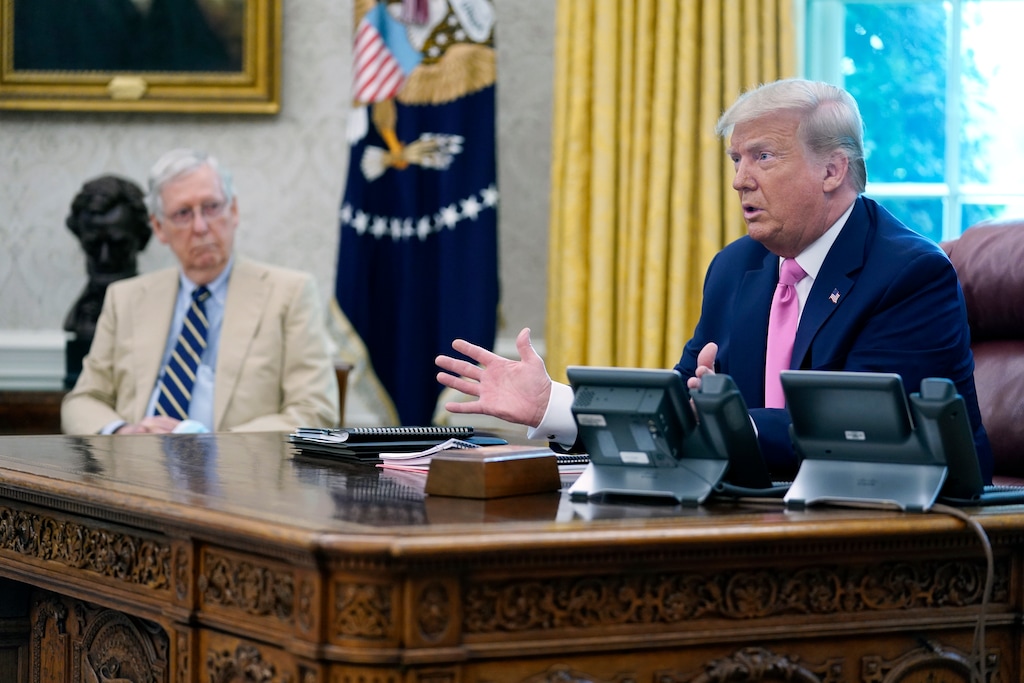 President Donald Trump meets with Senate Majority Leader Mitch McConnell, shown left, and House Minority Leader Kevin McCarthy, not shown, in the Oval Office at the White House, Monday, July 20, 2020, in Washington. Congress is just starting to negotiate new legislation to renew coronavirus aid. But the biggest obstacles to a deal are already coming into view. The Democratic House passed a whopping $3.5 trillion coronavirus response bill more than two months ago and is demanding robust funding to help state and local governments. Republicans want to keep the bill closer to $1 trillion and are insisting on new legal protections for schools, businesses, and charities that are trying to reopen. It’s up to top congressional leaders to bridge the gaps as they negotiate with President Donald Trump's White House.(AP Photo/Evan Vucci)
