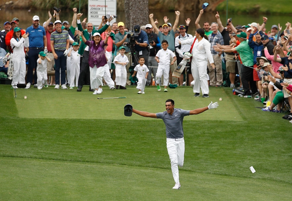 Tony Finau reacts after hitting a hole-in-one on the seventh home during the par three competition at the Masters golf tournament Wednesday, April 4, 2018, in Augusta, Ga. (AP Photo/Charlie Riedel)