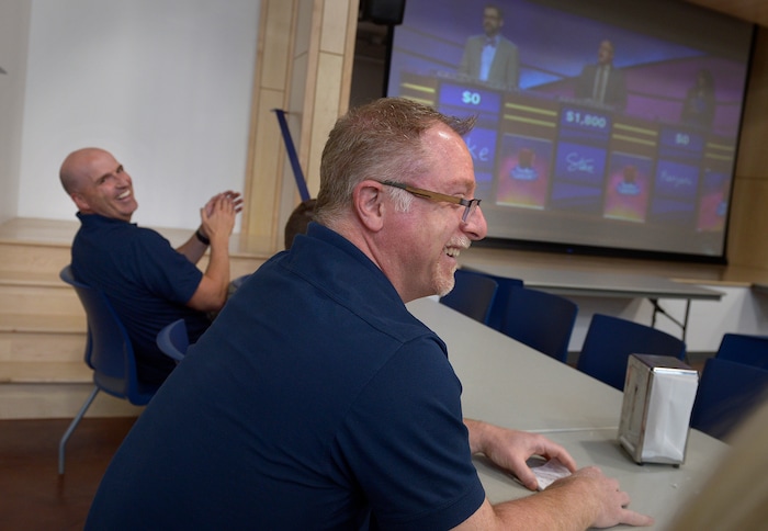 (Scott Sommerdorf | The Salt Lake Tribune)
Real Salt Lake Academy Director of Operations, Ryan Marchant, left, laughs as Academy math teacher Steve Mond reacts during the watch party at the school, Friday, May 11, 2018, as they showed Mond's performance in the JEOPARDY! Teachers Tournament.