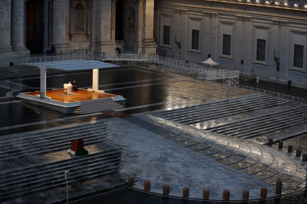 (Yara Nardi | Pool via AP) In this photo taken on March 27, 2020, Pope Francis, white figure standing alone at center, delivers an Urbi et orbi prayer from the empty St. Peter's Square at the Vatican.