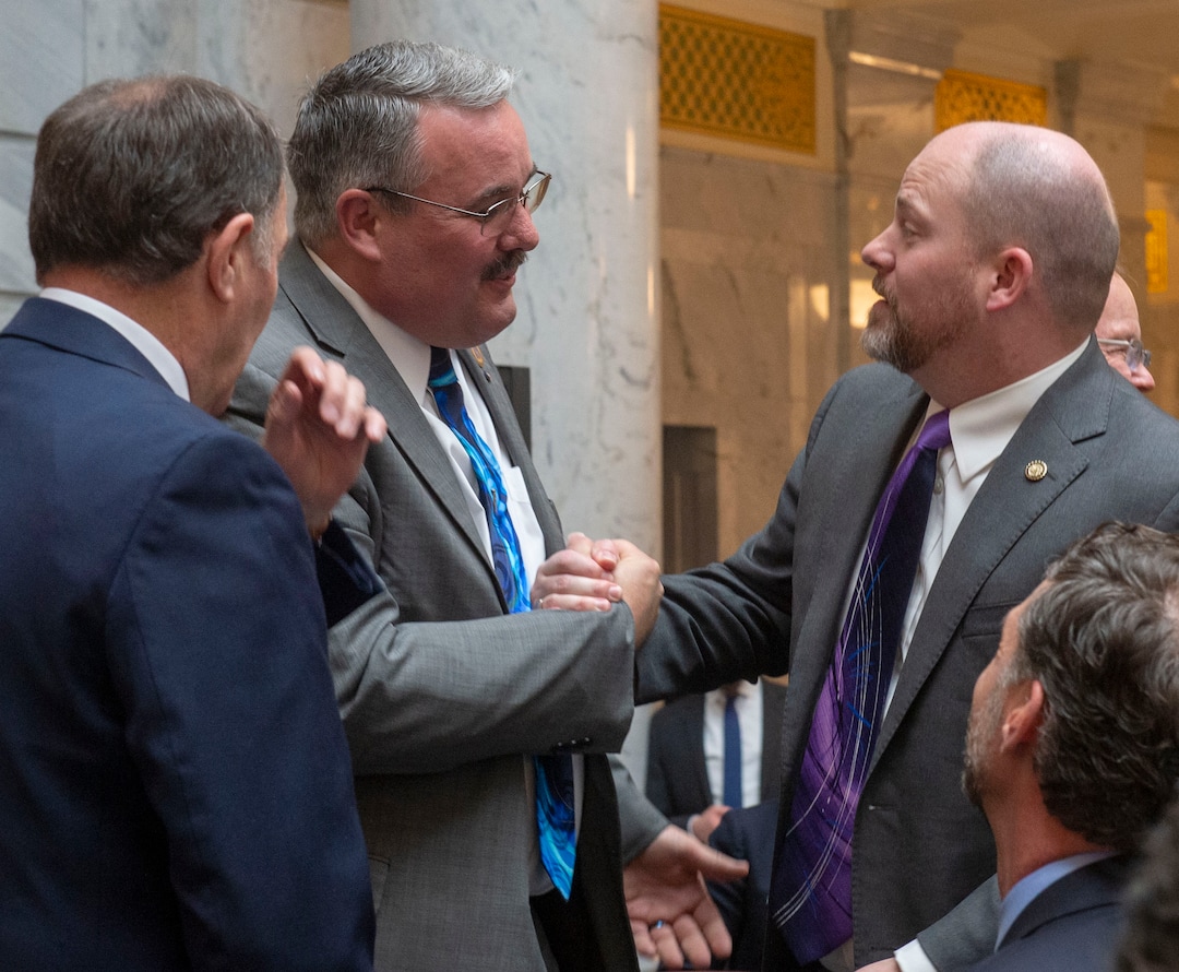 (Rick Egan  |  The Salt Lake Tribune)   Sen. Lee Perry shakes hands with Sen. Daniel Thatcher, after Gov. Gary R. Herbert signed the new hate crimes bill, at the Utah State Capitol, Tuesday, April 2, 2019.