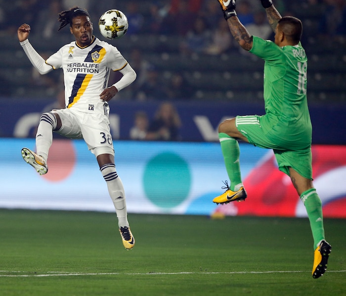 Los Angeles Galaxy forward Bradford Jamieson IV (38) kicks the ball over Real Salt Lake goalkeeper Nick Rimando (18) and the goal net during the first half of an MLS soccer game in Carson, Calif., Saturday, Sept. 30, 2017. (AP Photo/Alex Gallardo)