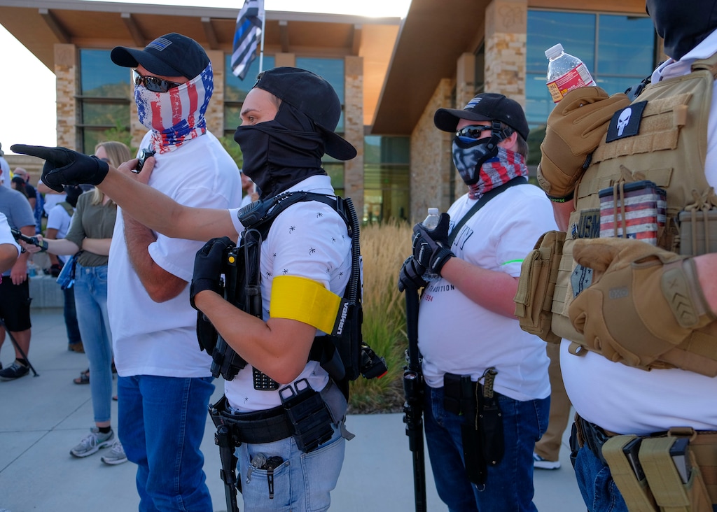 (Leah Hogsten | The Salt Lake Tribune) Utah Citizens' Alarm members attend the Friday, Aug. 7, 2020, Black Lives Matter rally in Cottonwood Heights. It was held five days after after nine protesters were arrested during a peaceful rally in memory of Zane James, killed by Cottonwood Heights police in 2018, that turned into a violent clash with Cottonwood Heights officers. Demonstrators gathered outside the police station Aug. 7 to denounce CHPD's actions, and UCA members watched.