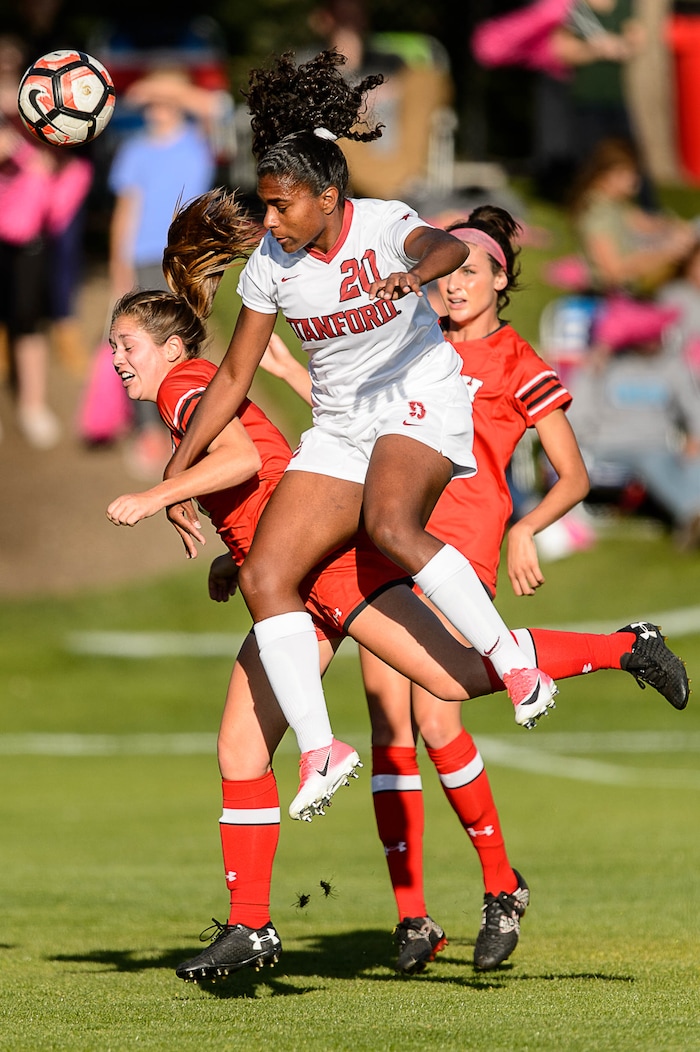 (Trent Nelson | The Salt Lake Tribune) Stanford's Catarina Macario (20) leaps over Utah's Janie Kearl (5) as the University of Utah hosts Stanford, NCAA Women's Soccer in Salt Lake City Thursday October 5, 2017.