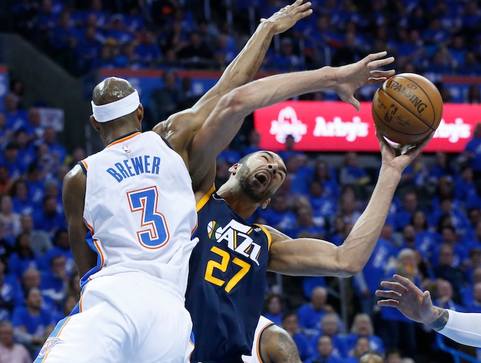 Utah Jazz center Rudy Gobert (27) is fouled by Oklahoma City Thunder forward Corey Brewer (3) as he shoots in the second half of Game 1 of an NBA basketball first-round playoff series in Oklahoma City, Sunday, April 15, 2018. (AP Photo/Sue Ogrocki)