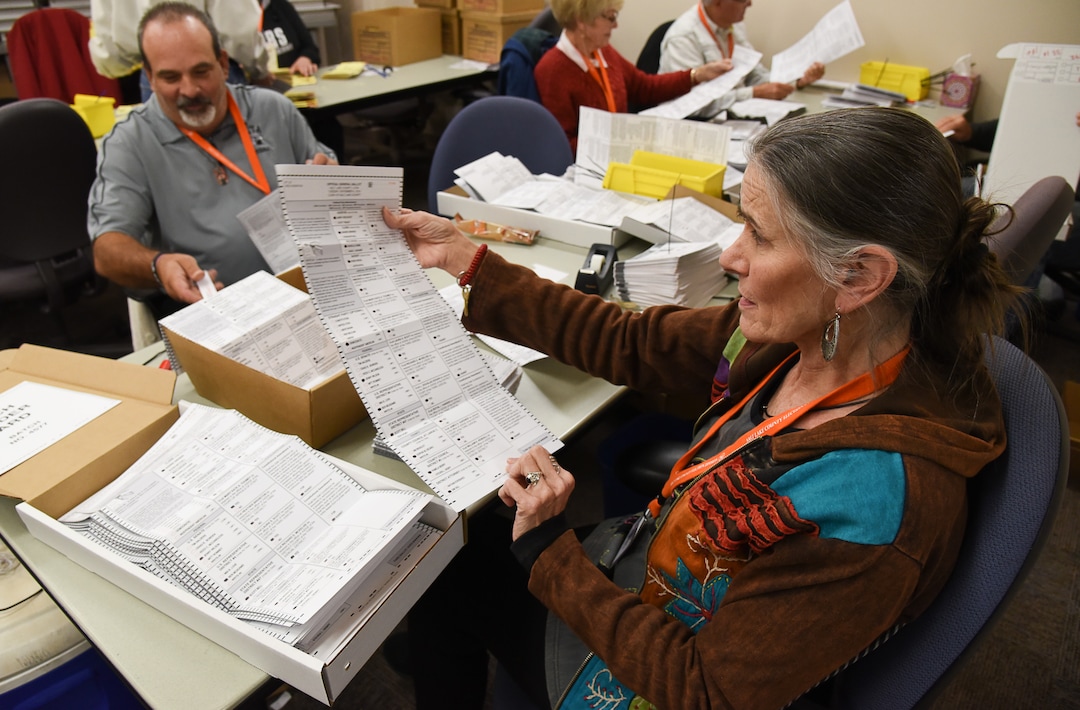 (Francisco Kjolseth  |  The Salt Lake Tribune)  Temporary elections workers Darrell Cole, left, and Ursula Jochmann check for any ballot problems as they process mailed in ballots on Tuesday, Oct. 30, 2018. Turnout numbers from the State Elections Office showed 359,219 people out of 1,390,679 active Utah voters have already cast their ballots as of Tuesday morning. Ten Salt Lake County early voting locations will open on Wednesday, but 1,059 voters have already taken advantage of voting at the Salt Lake County government offices. While many have already cast their ballots, there are some Utahns who haven't received theirs in the mail yet, which may create obstacles for them to vote.