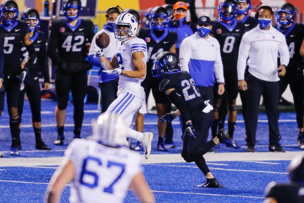 BYU wide receiver Neil Pau'u (2) turns back for the ball in front of Boise State guard Kekaula Kaniho (28) during the first half of an NCAA college football game Friday, Nov. 6, 2020, in Boise, Idaho. (AP Photo/Steve Conner)