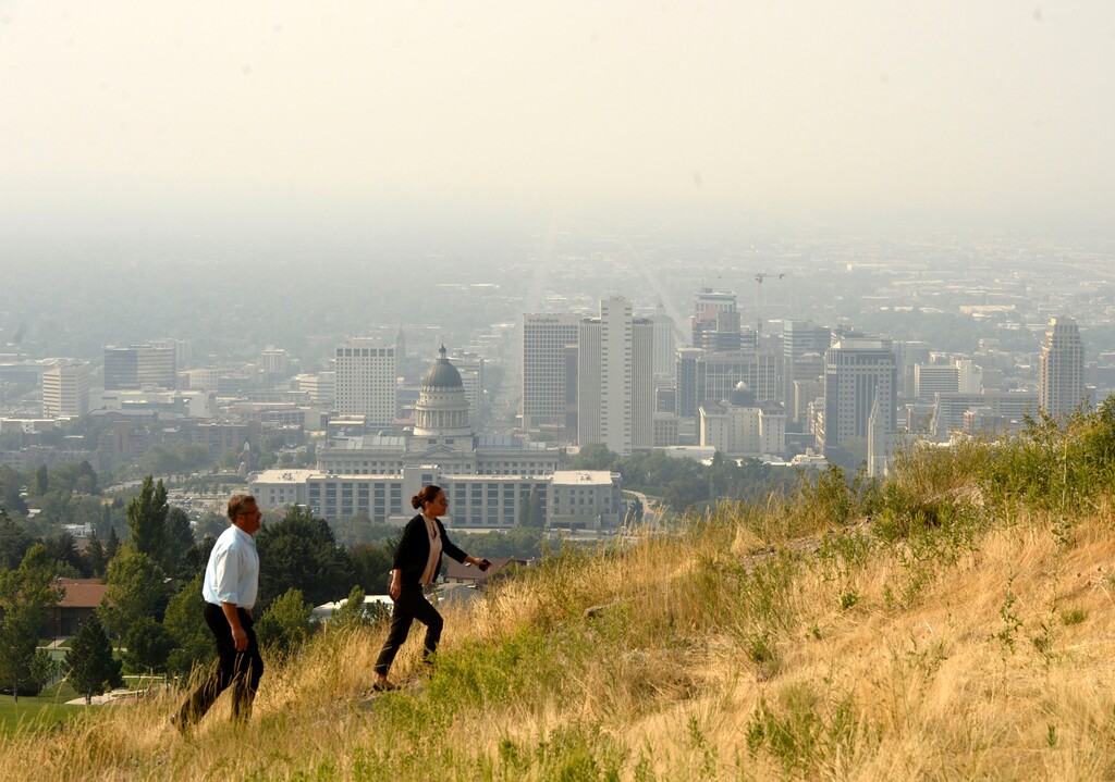 Al Hartmann | The Salt Lake Tribune
Smoke from wildfires to the west have drifted into northern Utah for the past few days making visibility dismal and air quality less than healthy. Couple climb trail at Ensign Peak Nature Park behind the Utah State Capitol Thursday August 21. Normally it provides a dramatic view of the valley and mountains. Today not much. Utah State Dept. of Environmental Quality recomends that person with existing heart or respiratroy ailmnents reduce physical exertions and outdoor activity.