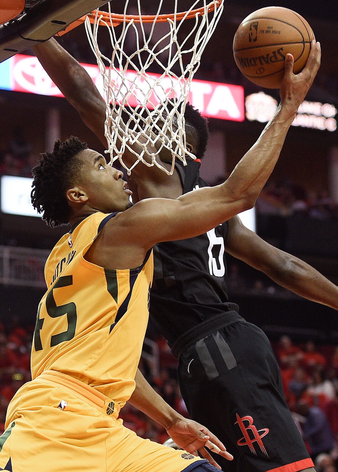 Utah Jazz guard Donovan Mitchell, left, shoots as Houston Rockets center Clint Capela defends during the second half in Game 1 of an NBA basketball second-round playoff series, Sunday, April 29, 2018, in Houston. (AP Photo/Eric Christian Smith)