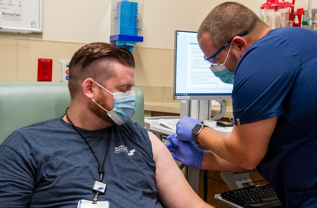 (Rick Egan | The Salt Lake Tribune) Braden Durney gets a COVID-19 vaccine from Brandon Widdison, as Lehi's Mountain Point Medical Center gives out its first COVID-19 vaccines on Thursday, Dec. 17, 2020.