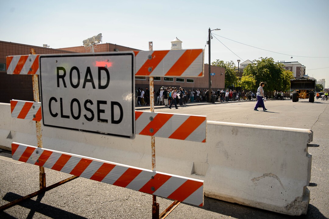 (Trent Nelson | The Salt Lake Tribune)  Needy people line up for lunch as workers install barriers on Rio Grande in Salt Lake City to prevent auto traffic in hopes of stopping the drug traffic around the area, Friday September 1, 2017.