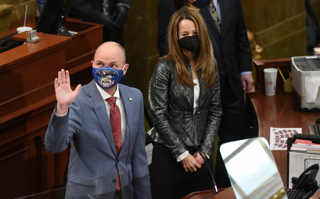 (Francisco Kjolseth  | The Salt Lake Tribune) Gov. Spencer Cox, alongside his wife Abby Cox, are greeted as they enter the House chamber for the State of the State address at the Capitol in Salt Lake City on Thursday, Jan. 21, 2021.