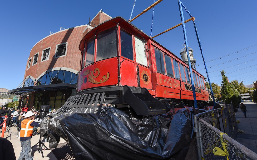 (Francisco Kjolseth  |  Francisco Kjolseth)  The iconic trolley car, that has been sitting in storage for several years, is moved back into view at Trolley Square on Monday, Oct. 15, 2018 as people gather for the repositioning ceremony. The empty trolley car, last seen housing the Trolley Wing Company was moved into place on the north plaza by Pottery Barn.