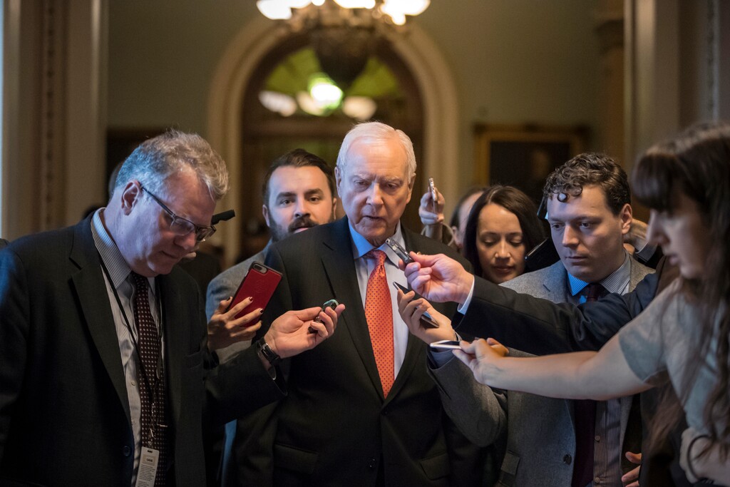 (J. Scott Applewhite  |  AP Photo)  Reporters ask questions of Sen. Orrin Hatch, R-Utah, chairman of the tax-writing Finance Committee, as he walks to meet with Senate Majority Leader Mitch McConnell, R-Ky., on the GOP effort to overhaul the tax code, on Capitol Hill in Washington, Friday, Dec. 1, 2017.