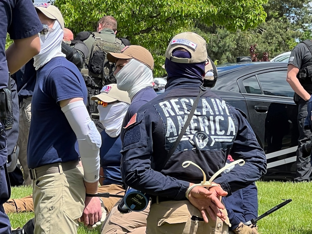 (Georji Brown via AP) Authorities arrest members of the white supremacist group Patriot Front near an Idaho pride event Saturday, June 11, 2022, after they were found packed into the back of a U-Haul truck with riot gear.