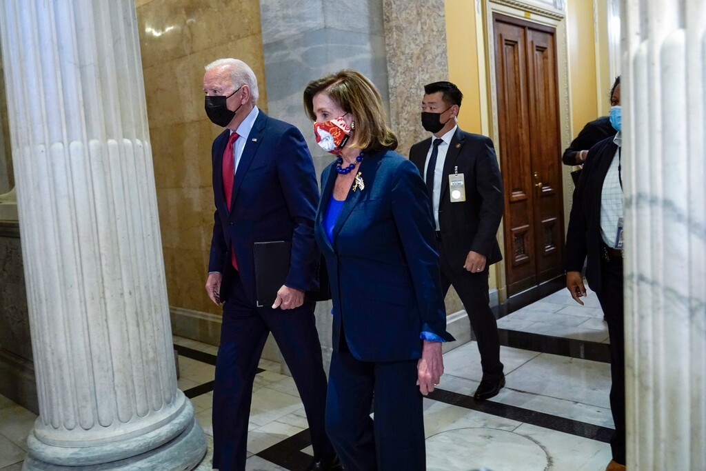 (Susan Walsh | AP) President Joe Biden walks with House Speaker Nancy Pelosi of Calif., on Capitol Hill in Washington, Friday, Oct. 1, 2021, for a meeting with the House Democratic caucus to try to resolve an impasse around the bipartisan infrastructure bill.