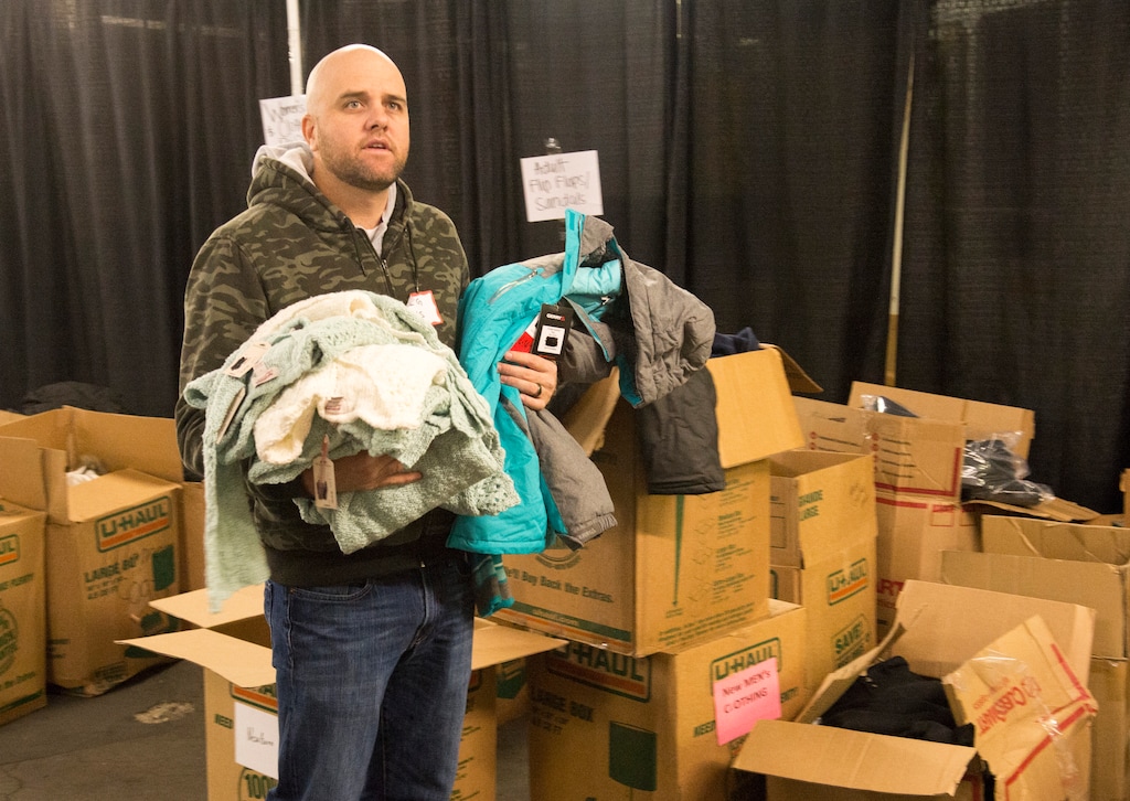 (Rick Egan | Tribune file photo) Kris Stewart , a volunteer from Cottonwood Insurance, looks for the proper boxes, as he sorts clothing at the Candy Cane Corner, which gives homeless families an opportunity to shop for Christmas, Friday, December 2, 2016.