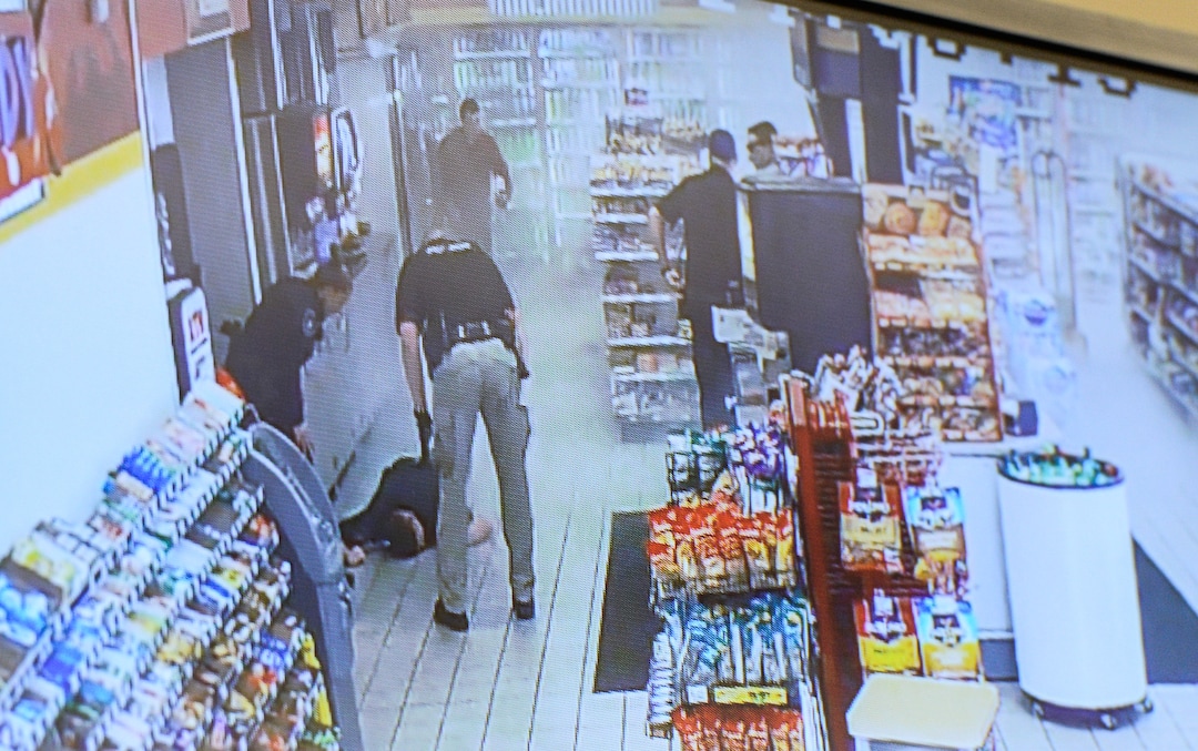 (Francisco Kjolseth  |  The Salt Lake Tribune)  Kaysville Officer Robert Jackson lies on the floor of a convenience store gas station after a suicidal subject lit himself on fire on April 5, 2018, subsequently burning several officers who were trying to calm him down. The Kaysville police department aired the surveillance footage during a press event featuring the officers involved, including Jackson who appeared by video as he recovers from his injuries at University hospital. 