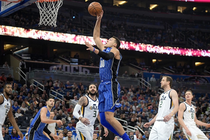 Orlando Magic forward Aaron Gordon (00) goes up for a shot between Utah Jazz forward Derrick Favors (15), guard Ricky Rubio (3), forward Joe Ingles (2) and forward Jonas Jerebko (8) during the first half of an NBA basketball game Saturday, Nov. 18, 2017, in Orlando, Fla. (AP Photo/Phelan M. Ebenhack)