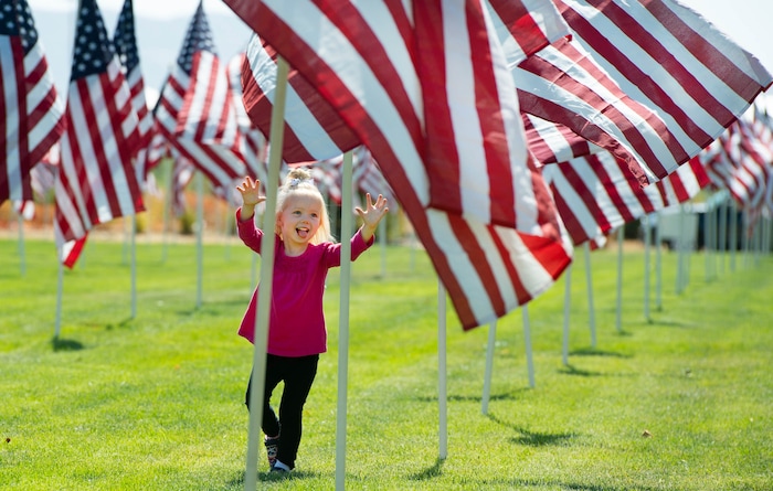 (Francisco Kjolseth | The Salt Lake Tribune) Hazel, 3, no last name given, runs amongst the flags as the Utah Healing Field marks the 19th anniversary of the 9/11 attacks on Friday, Sept. 11, 2020. , Flapping in a gentle breeze, 1500 flags fly on the promenade outside Sandy City Hall.