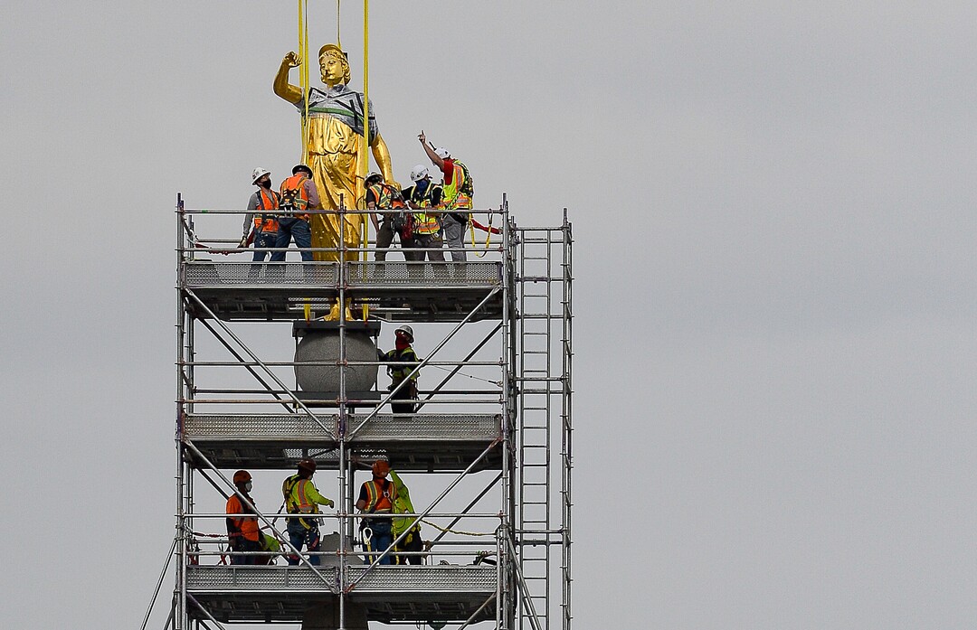 (Francisco Kjolseth  |  The Salt Lake Tribune) Crews work to remove the Angel Moroni statue atop the Salt Lake Temple of The Church of Jesus Christ of Latter-day Saints on Monday, May 18, 2020. The temple closed in December for seismic upgrades and sustained minor damager during the March 18, 2020, magnitude 5.7 earthquake when the trumpet held by the angel fell off and several smaller spire stones were displaced.