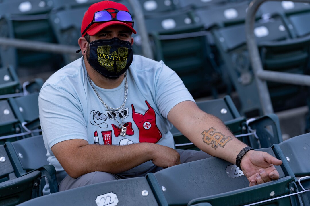 (Francisco Kjolseth | The Salt Lake Tribune) Salt Lake Bees fan Anthony Lujan shows off his team tattoo as he remarks “I go all the way back to the Trapper’s days,” as he attends the season opener Thursday night, May 6, 2021, after shutting down last season due to the pandemic.