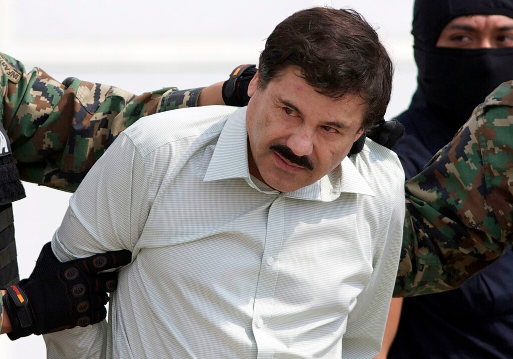 (Eduardo Verdugo | AP file photo) This Feb. 22, 2014 file photo shows Joaquin "El Chapo" Guzman, the head of Mexico's Sinaloa Cartel, being escorted to a helicopter in Mexico City following his capture in the beach resort town of Mazatlan.