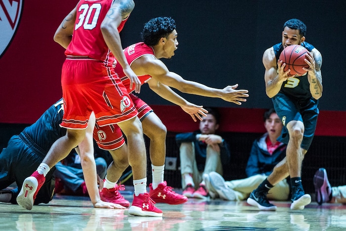 (Chris Detrick  |  The Salt Lake Tribune)  Utah Utes guard Sedrick Barefield (0) and Missouri Tigers guard Kassius Robertson (3) go for the ball during the game at the Jon M. Huntsman Center Thursday, November 16, 2017.   