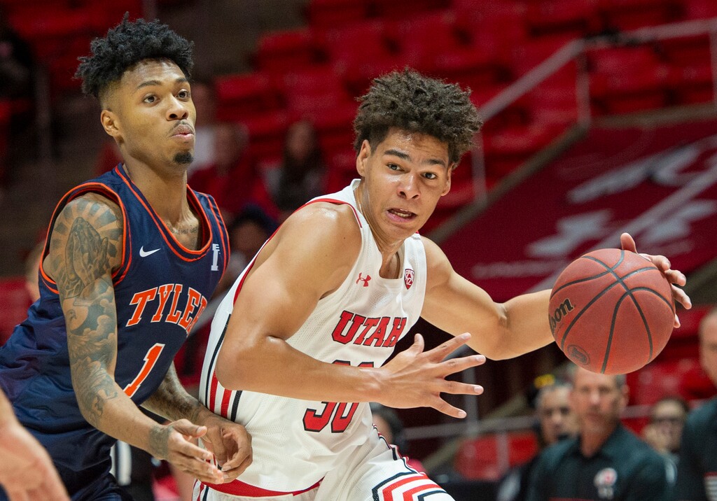 (Rick Egan  |  The Salt Lake Tribune)  Utah Utes guard Brendan Wenzel (30) makes a move inside, as University of Texas at Tyler Patriots Bradley Mason (1) defends, in basketball action between the Utes and the University of Texas at Tyler Patriots, at the Jon M. Huntsman Center, Oct. 30, 2019.