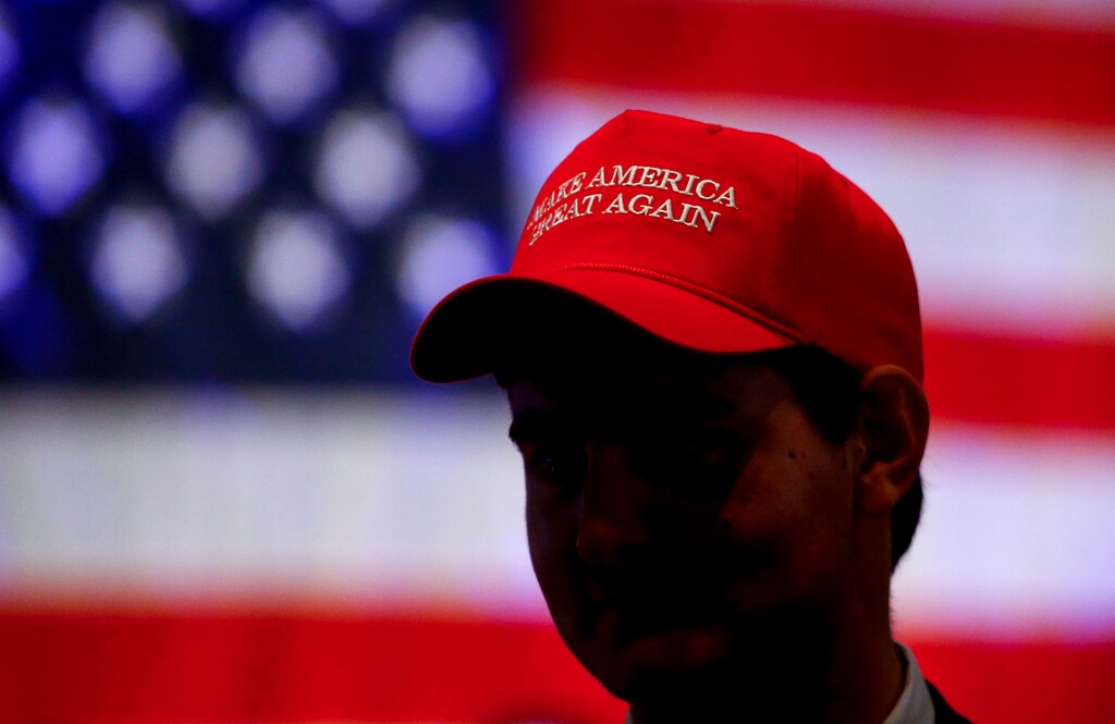 (Butch Dill | The Associated Press) In this Nov. 6, 2018, a man wears a hat with President President Donald Trump's campaign slogan in Montgomery, Ala.