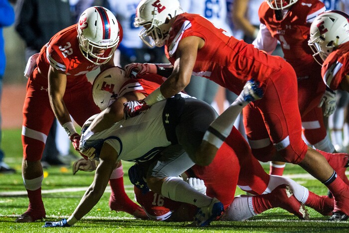 (Chris Detrick  |  The Salt Lake Tribune)  East's Tennessee Pututau (9) East's Andre Toilolo (32) East's Sam Vakalahi (53) and East's Nic Harris (16) tackle IMG Academy's Jermaine Burton (10) during the game at East High School Friday, October 20, 2017. 