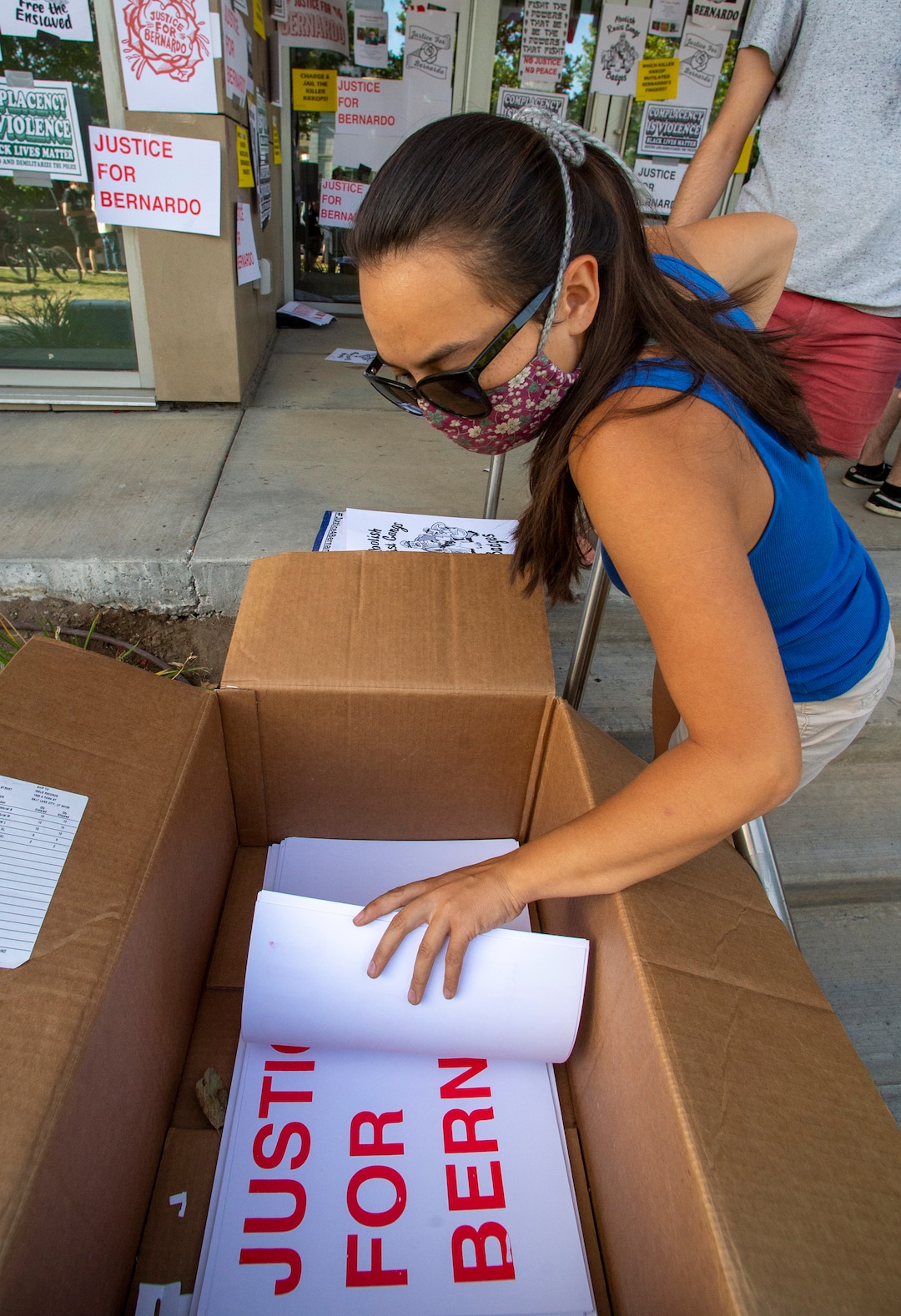 (Rick Egan  |  The Salt Lake Tribune)      Protesters grab signs to put on the Salt Lake District Attorney's office, during a Justice for Bernardo demonstration, in Salt Lake City, Tuesday, July 7, 2020.