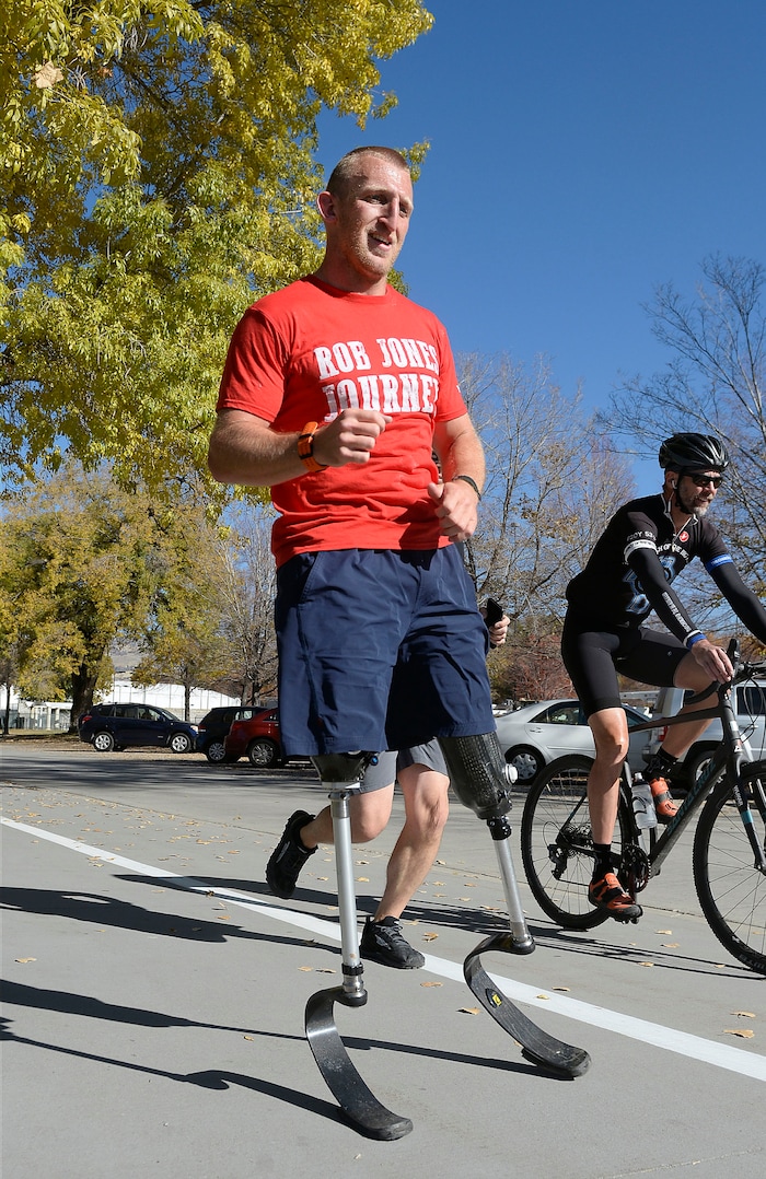 Al Hartmann | The Salt Lake Tribune)
Rob Jones, a retired Marine Corps Sergeant who lost both legs when he stepped on an improvised explosive device in Afghanistan, runs a marathon, (26.2) miles in Liberty Park in Salt Lake City Wednesday Oct. 25. He won a Bronze Medal in the Paralympics and he wis the first and only double above the knee amputee to ride a normal bicycle 5,180 miles across America. Now, he is set to run 31 marathons in 31 days in 31 major cities. Starting in London on October 12th, and continuing in the United States and Toronto, he will run 26.2 miles in the selected city on his own, travel to the next city, and repeat, ending appropriately on Veterans Day in our Nation’s Capital. His motto, “Survive. Recover. Live.”