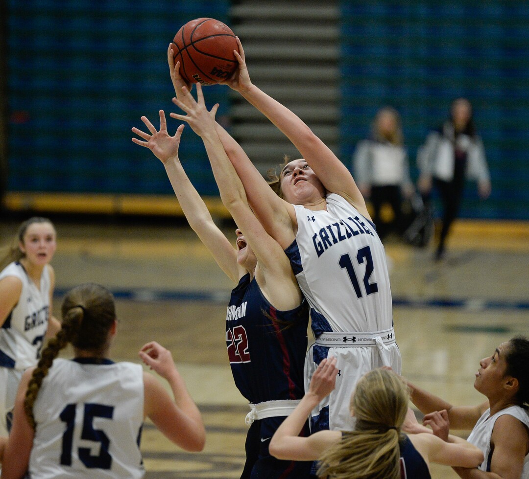 (Francisco Kjolseth  |  The Salt Lake Tribune)  Herriman's  Payton Nelson and Taela Laufiso of Copper Hills battle for a rebound in game action in West Jordan on Thursday, Jan. 25, 2018.