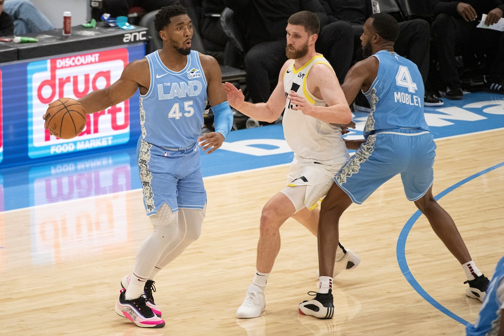 (Phil Long | AP) Cleveland Cavaliers' Donovan Mitchell (45) looks to pass as Utah Jazz Svi Myhailiuk, center, is blocked by Evan Mobley (4) during the first half of an NBA basketball game in Cleveland, Monday Dec. 23, 2024.