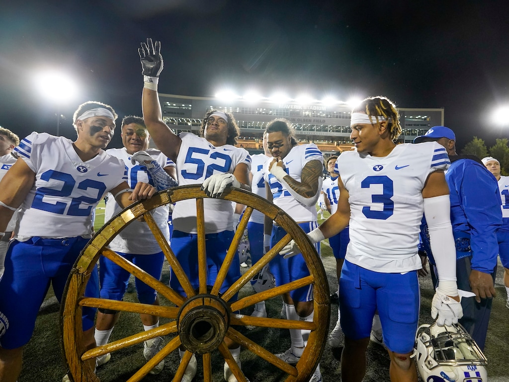 (Leah Hogsten | The Salt Lake Tribune) BYU celebrates the win as the Utah State Aggies host Brigham Young University Cougars at Maverik Stadium Oct. 1, 2021. The Cougars attempt a second straight win for the Wagon Wheel, the trophy of the in-state rivalry, while the Aggies will try to recapture the trophy.