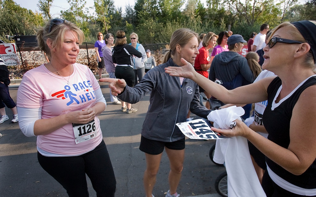 Scott Sommerdorf | The Salt Lake Tribune
Meri Brown, left, from the TV program "Sister Wives," carries on a conversation with a friend near the starting line of the 5K run to benefit Holding Out Help, a group that helps people leaving polygamy. The run started at 9 a.m. from Draper City Park, Saturday, Sept. 22, 2012.