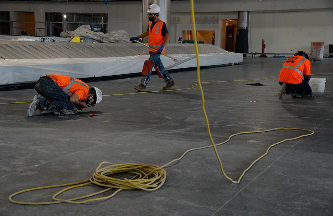 (Francisco Kjolseth  |  The Salt Lake Tribune) Crews pay close attention to polished terrazzo floors made up chips of marble and other stone products with cement or epoxy, forming a strong, durable flooring surface as crews continue their work in the first phase of construction of the Salt Lake City International Airport on Wednesday, May 20, 2020.