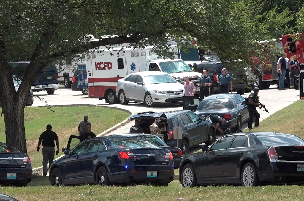 Authorities mobilize near 27th Street and Van Brunt Boulevard after three police officers were shot Sunday, July 15, 2018, in Kansas City, Mo., while trying to arrest a person of interest in the shooting death of a university student on July 6. The suspect died in an exchange of gunfire with police. The officers suffered non-life threatening injuries. (Tammy Ljungblad/The Kansas City Star via AP)