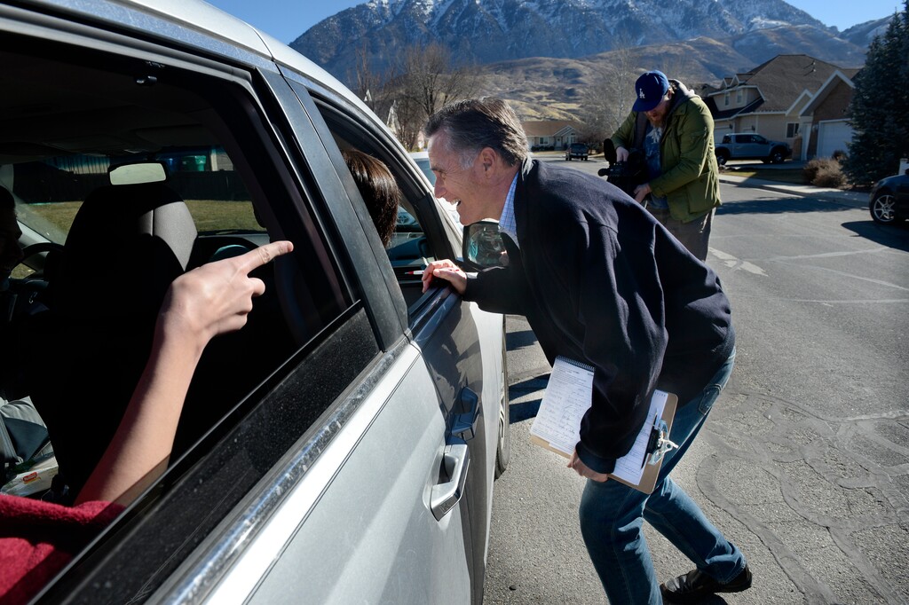 (Scott Sommerdorf | The Salt Lake Tribune) Former Republican presidential candidate Mitt Romney met with Marc and Rachael Gibson as they stopped their van to speak with him on 640 West in Orem while the candidate was collecting signatures in the neighborhood, Saturday, Feb. 17, 2018.